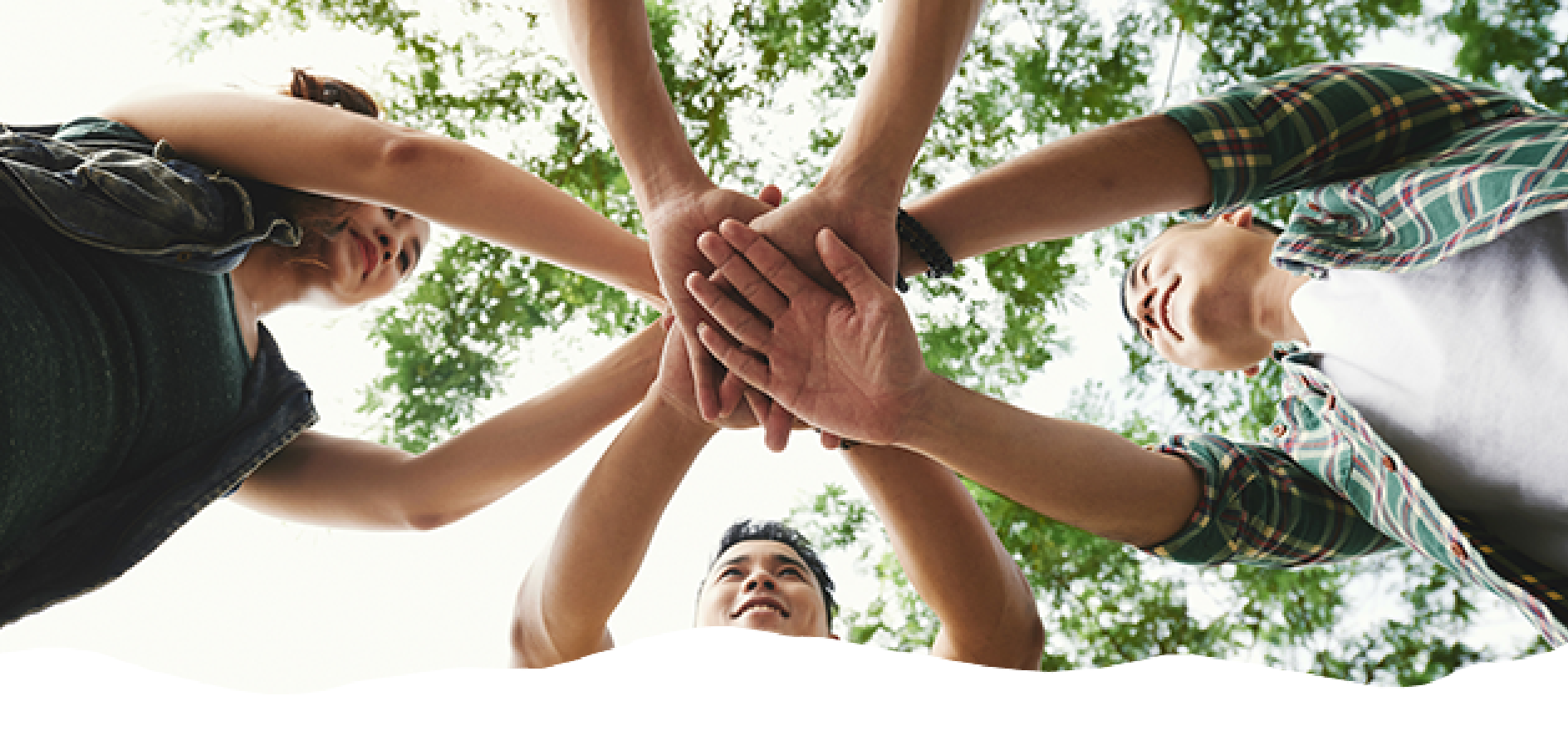Teens putting their hands together for teamwork after treatment at BlueRock Behavioral Health