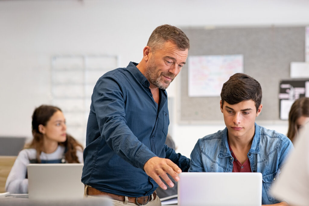 teacher with teenage students in the classroom at BlueRock