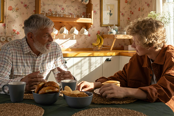 Grandfather and grandson together at the table in the kitchen