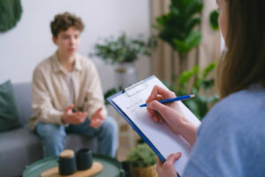Teen talking one-on-one with a counselor at BlueRock Behavioral Health